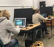 Students processing digital photographs in wildlife computer photography lab 