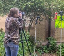 Kelly Wood photographing hummingbirds in Wildlife Photography class